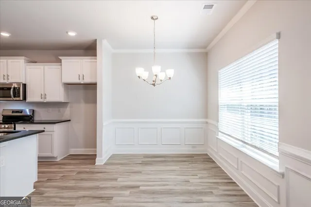 a view of a kitchen with wooden floor and a window