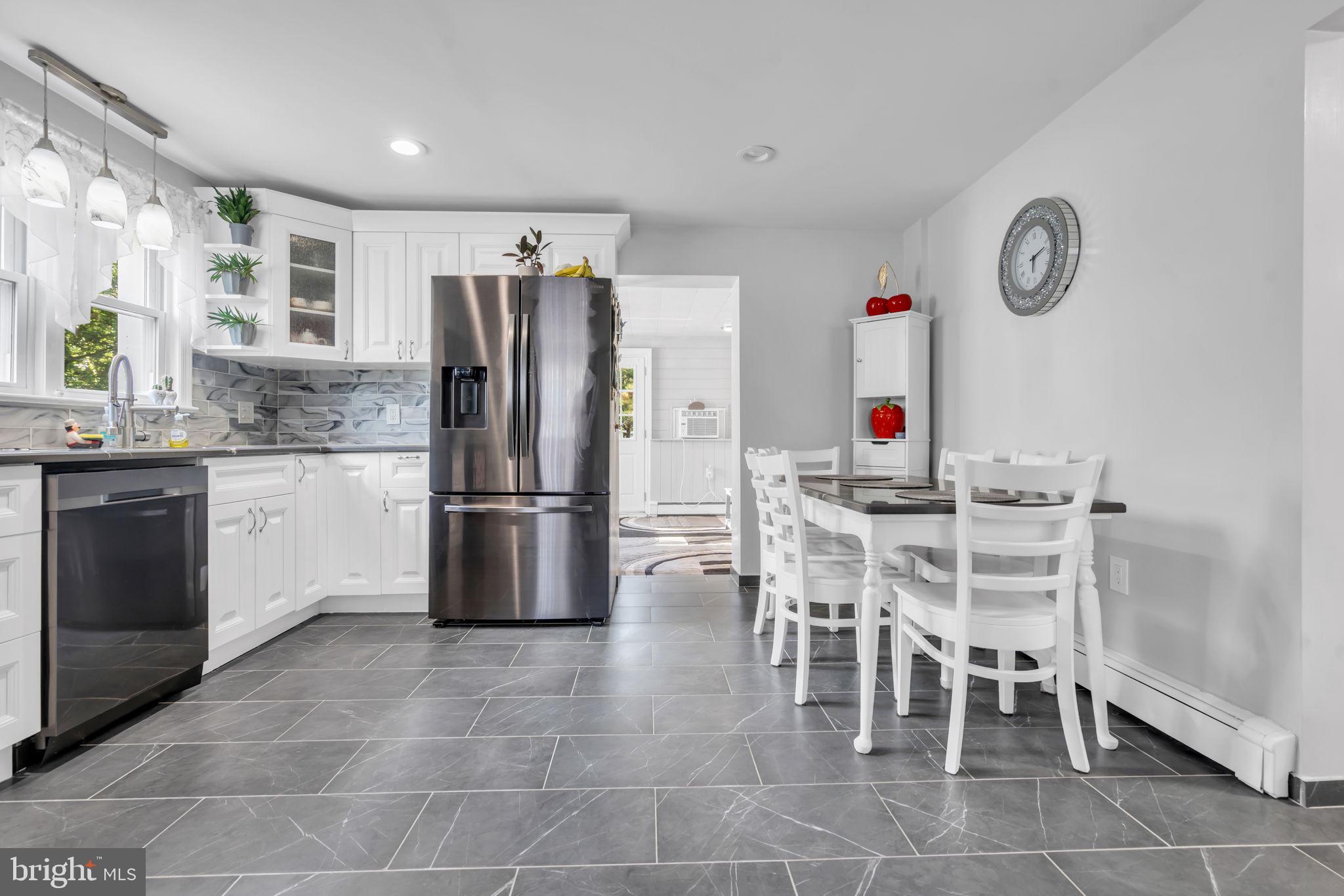 80 Locust Avenue Hamilton, NJ 08620 - Photo 11 of 24 a kitchen with stainless steel appliances granite countertop a stove refrigerator and a sink
