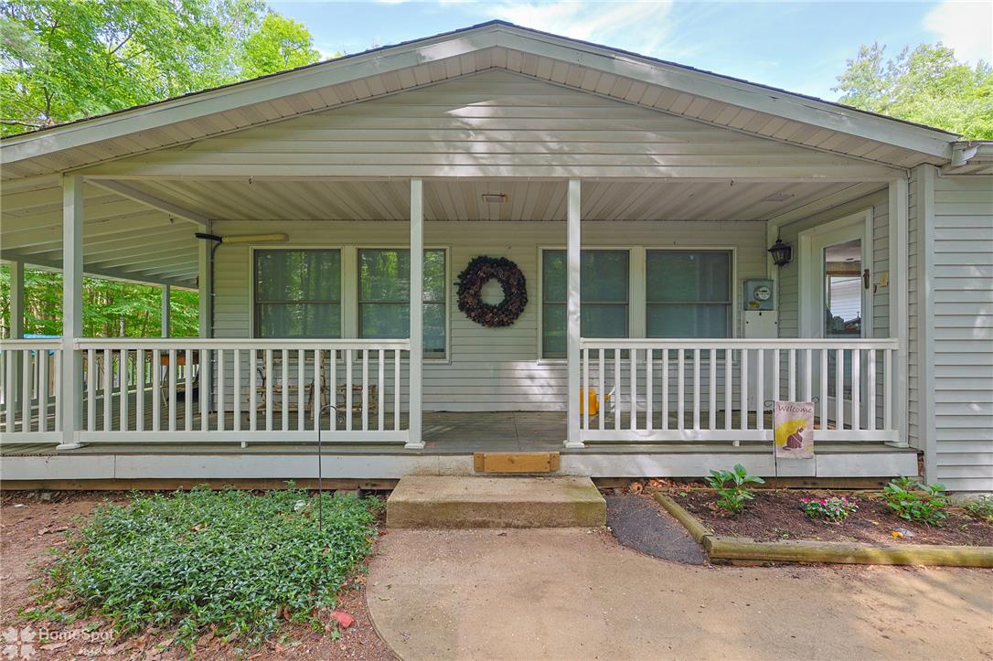 60 Sassafras Road Lehighton, PA 18235 - Photo 2 of 51 A welcoming covered porch with a sturdy railing offers a charming entry to this residence.