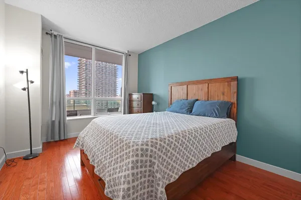 a bed sitting in a bedroom next to a window