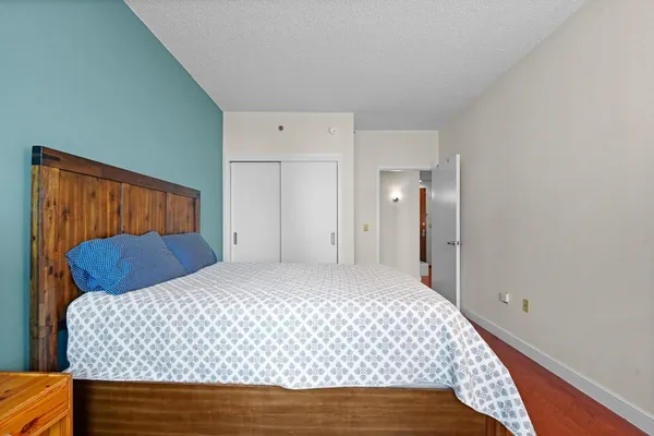 a bedroom with a bed and mirror