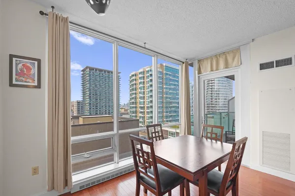 a view of a dining room with furniture window and wooden floor