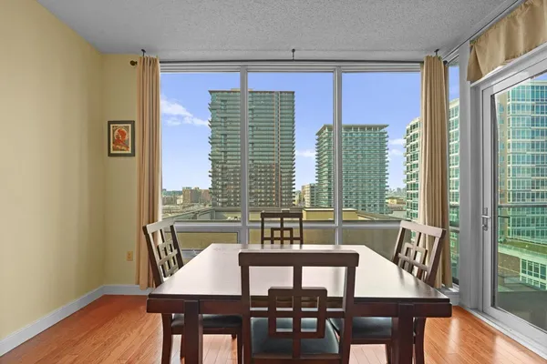 a view of a dining room with furniture and wooden floor