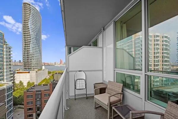 a balcony with table and chairs