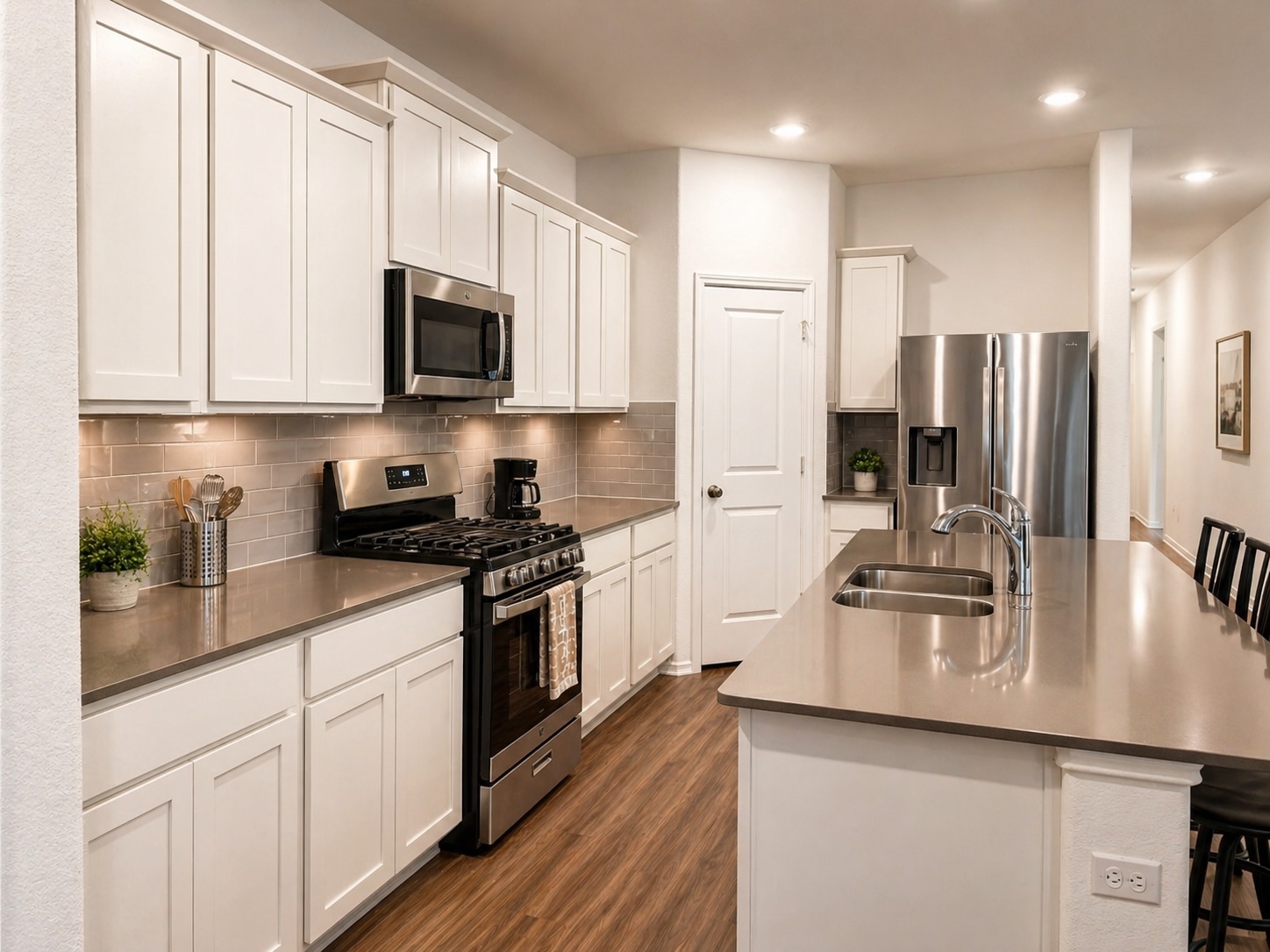 108 Blue Blaze Trail Georgetown, TX 78628 - Photo 6 of 26 a kitchen with stainless steel appliances granite countertop a sink refrigerator stove and microwave