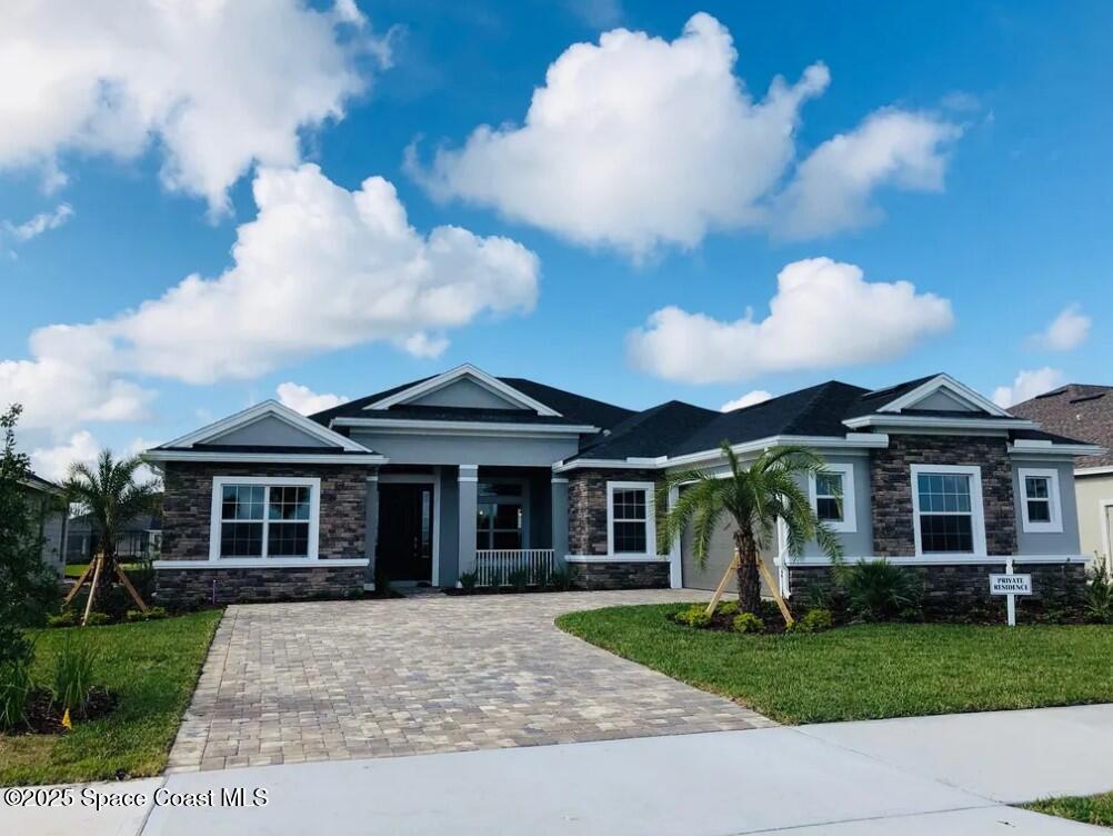 2855 Trasona Drive Melbourne, FL 32940 - Photo 1 of 5 a front view of a house with a garden