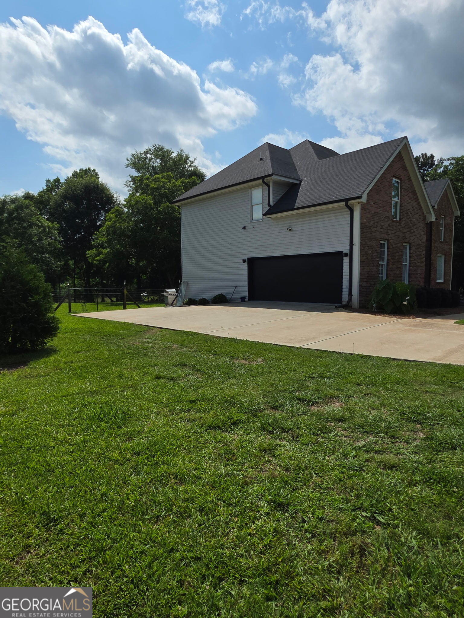 892 Perimeter Road Monticello, GA 31064 - Photo 30 of 38 a house that is sitting in the grass with large trees