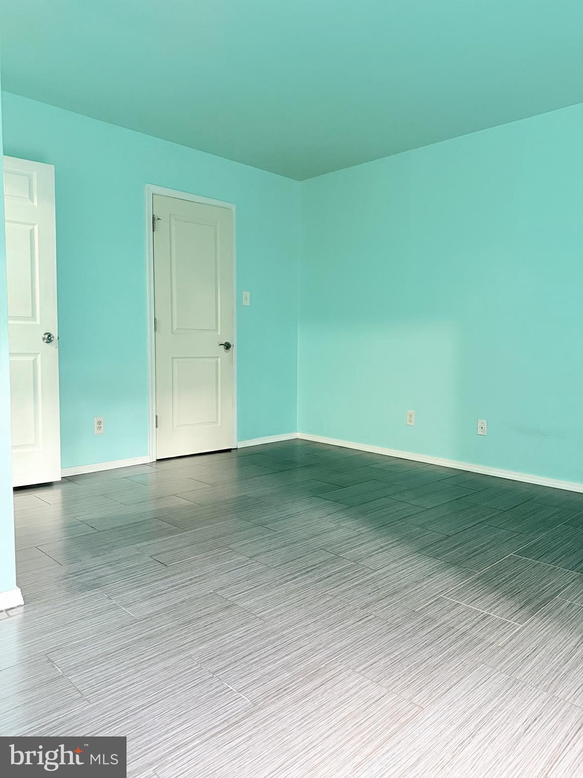 11206 Cherry Hill Road, Unit 92 Beltsville, MD 20705 - Photo 12 of 18 a view of empty room with wooden floor and fan