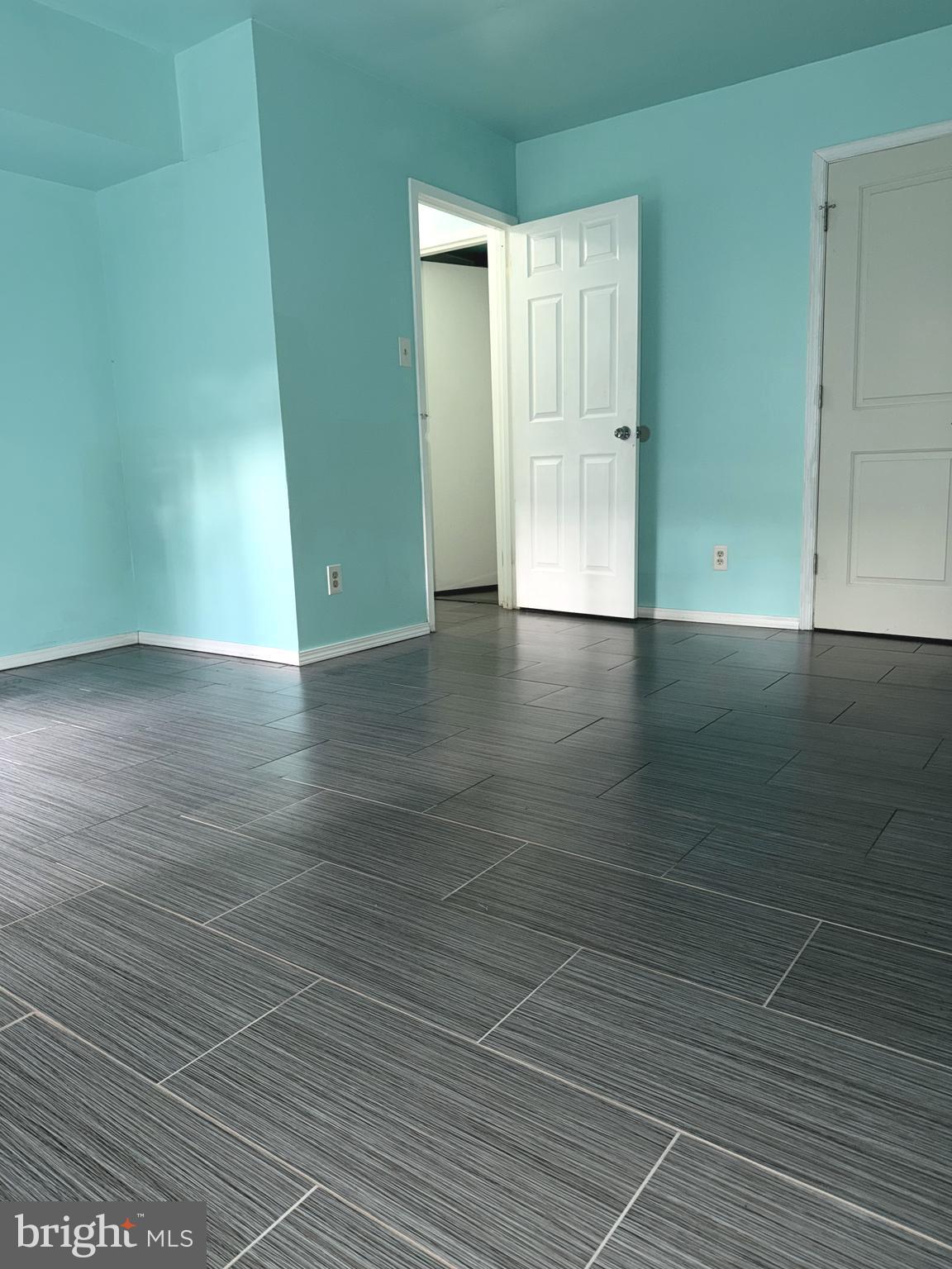 11206 Cherry Hill Road, Unit 92 Beltsville, MD 20705 - Photo 13 of 18 an empty room with wooden floor and windows