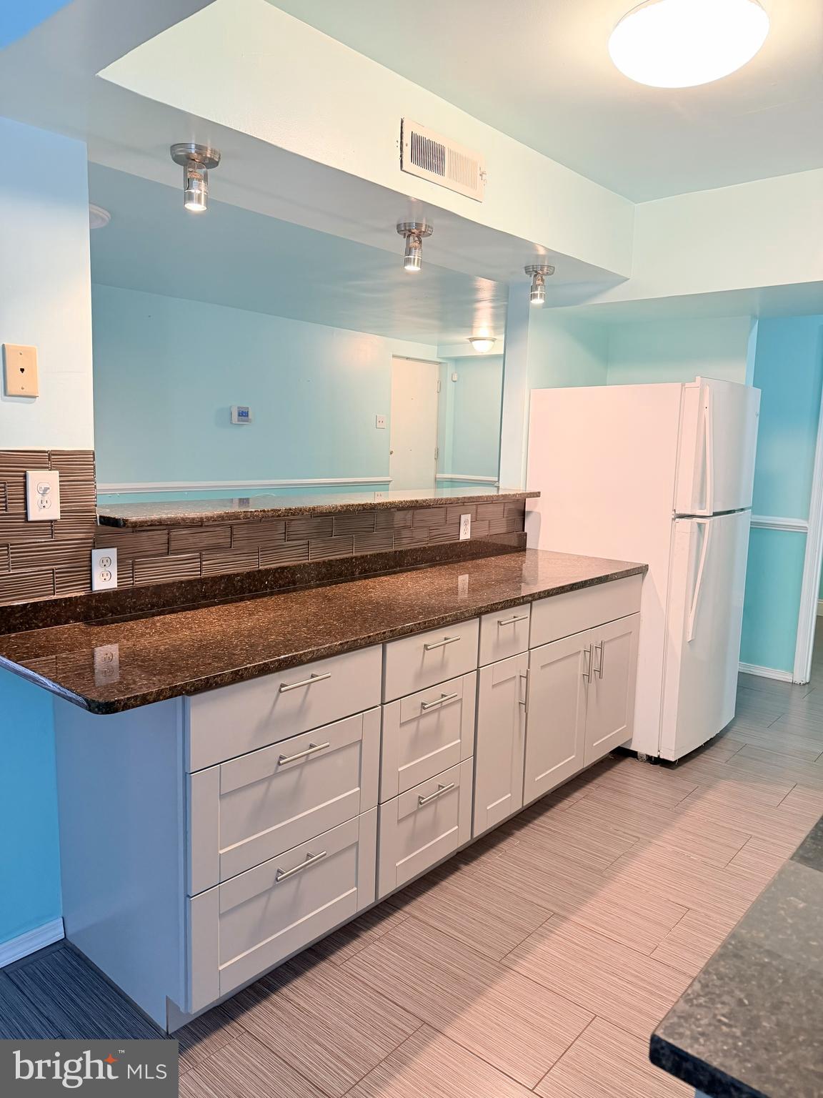11206 Cherry Hill Road, Unit 92 Beltsville, MD 20705 - Photo 6 of 18 a spacious bathroom with a granite countertop sink and a mirror