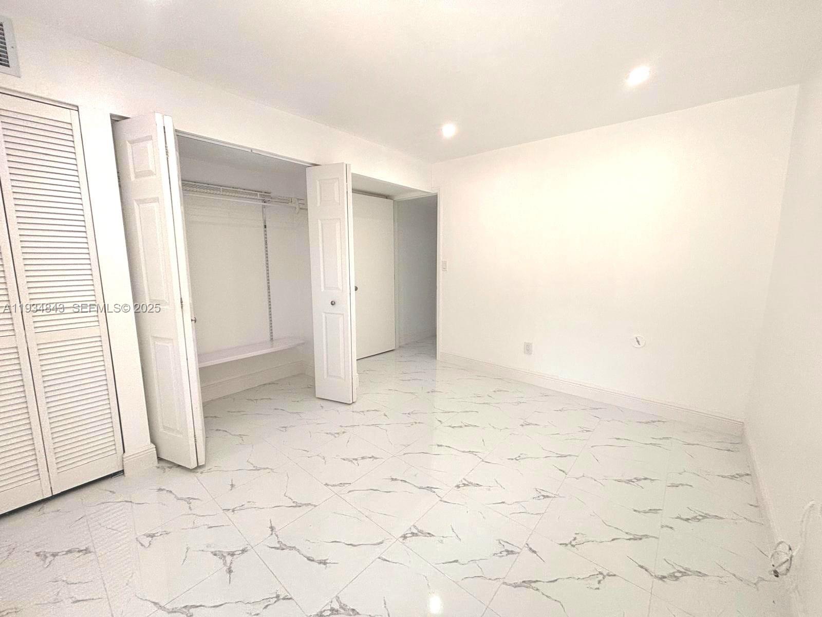 14402 Southwest 111th Street, Unit 14402 Miami, FL 33186 - Photo 13 of 21 a view of an empty room