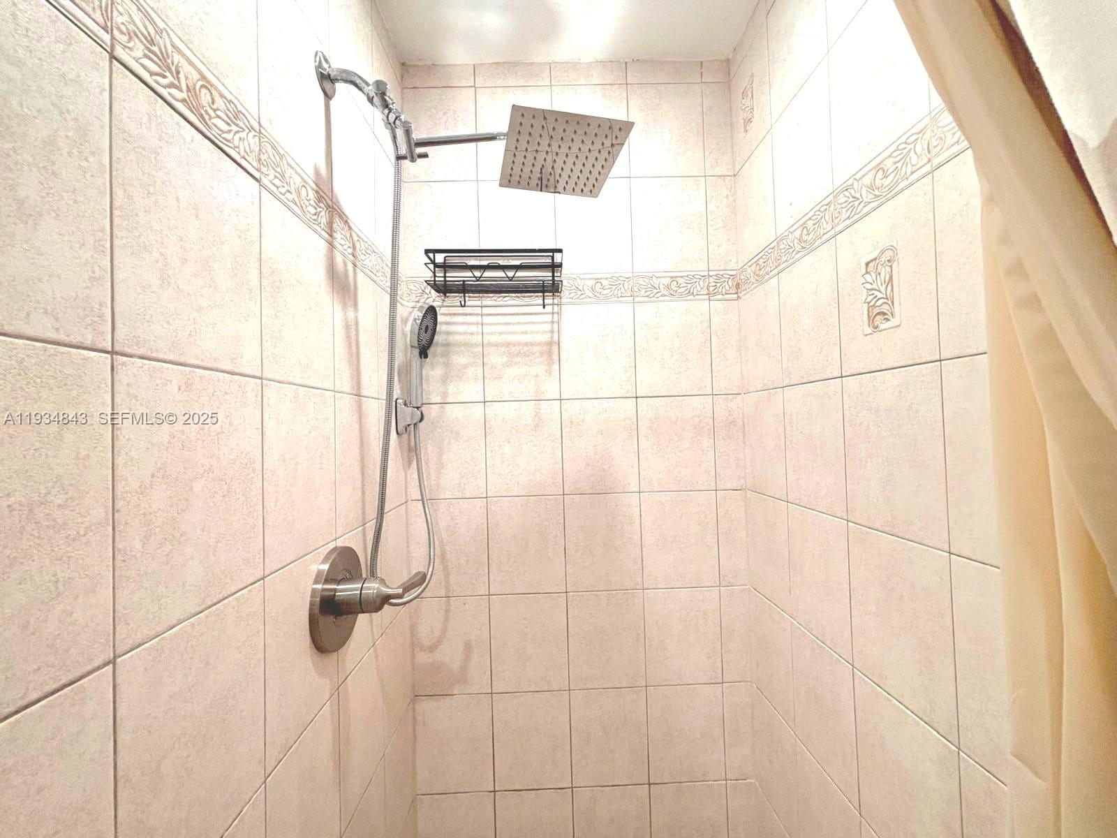 14402 Southwest 111th Street, Unit 14402 Miami, FL 33186 - Photo 18 of 21 a bathroom with a shower
