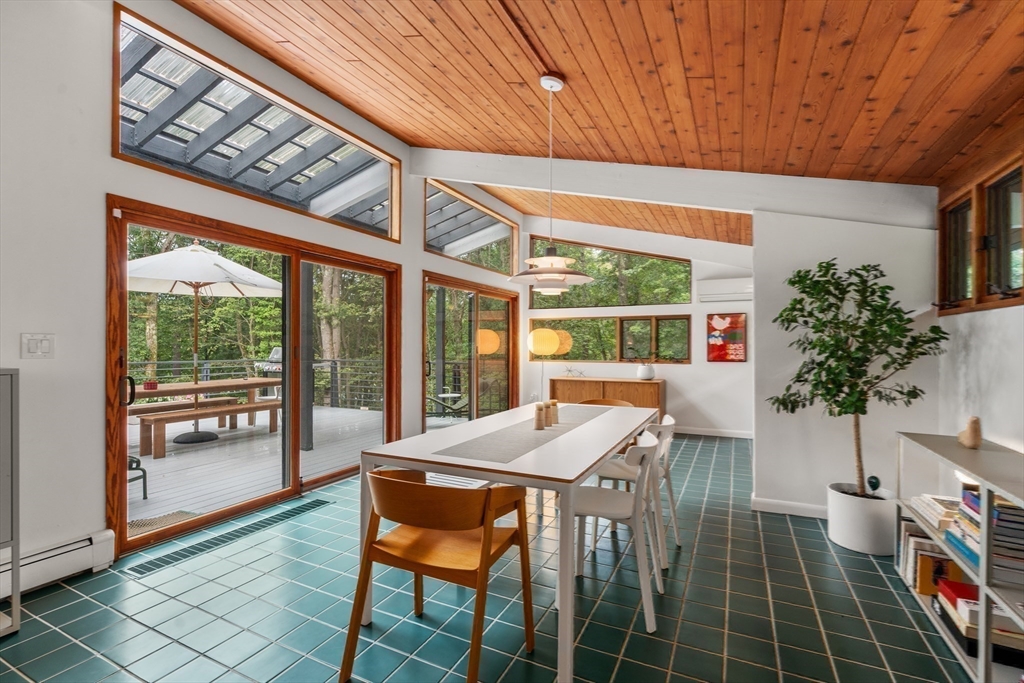 43 Willowdale Road Topsfield, MA 01983 - Photo 11 of 34 a view of a patio with table and chairs potted plants with wooden floor