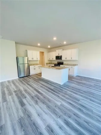 a view of kitchen and wooden floor