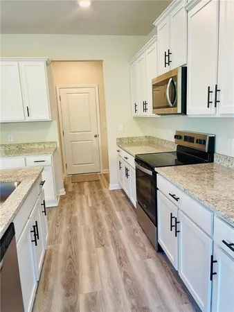 a kitchen with a sink stove and cabinets