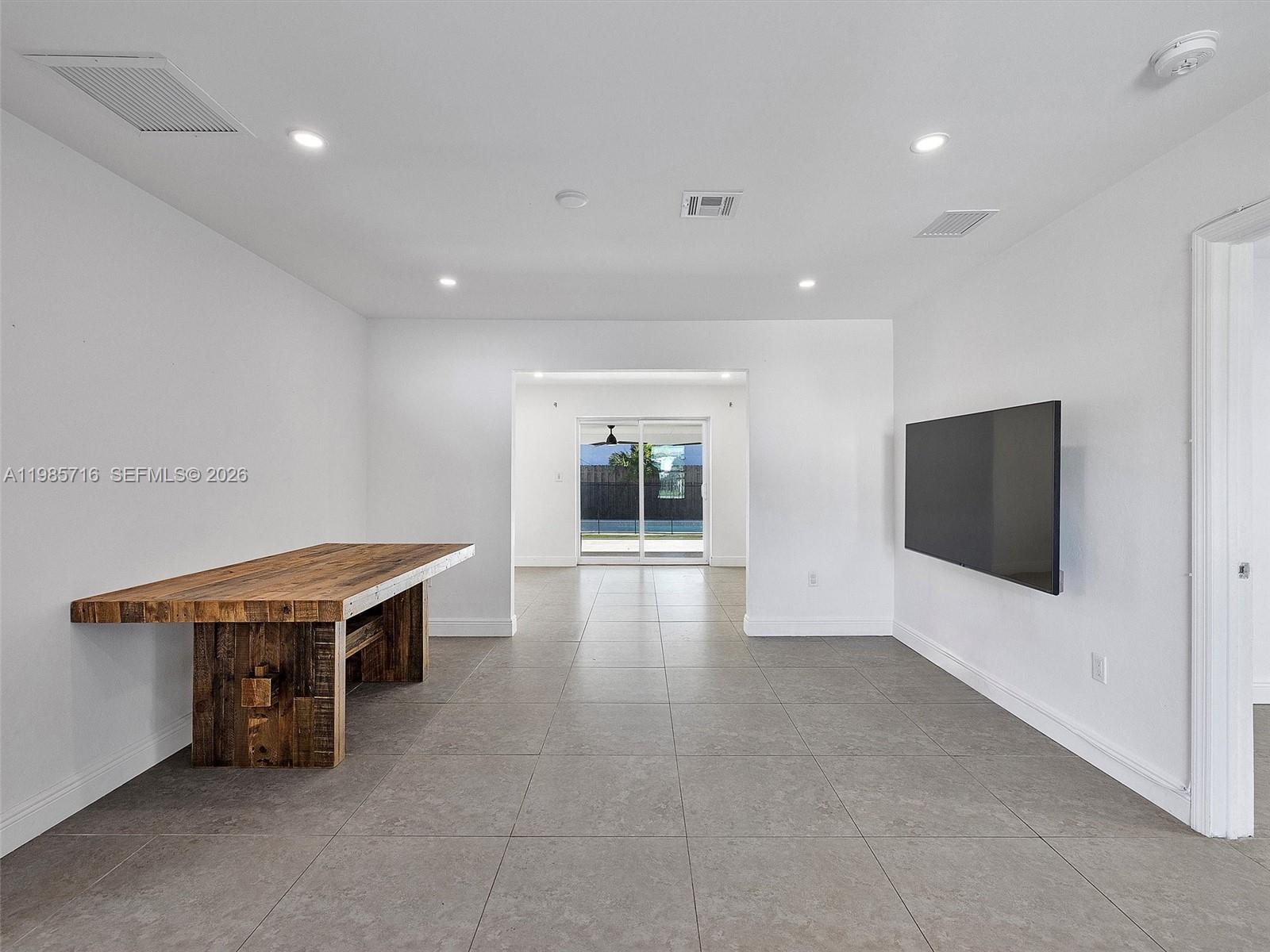 340 Northwest 45th Street Miami, FL 33127 - Photo 11 of 25 an empty room with windows and fireplace