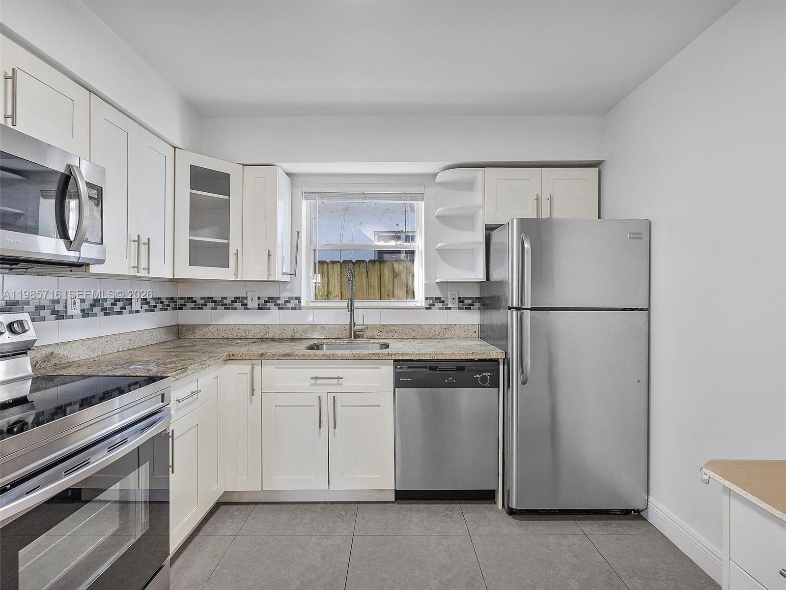 340 Northwest 45th Street Miami, FL 33127 - Photo 14 of 25 a kitchen with a refrigerator sink and stove