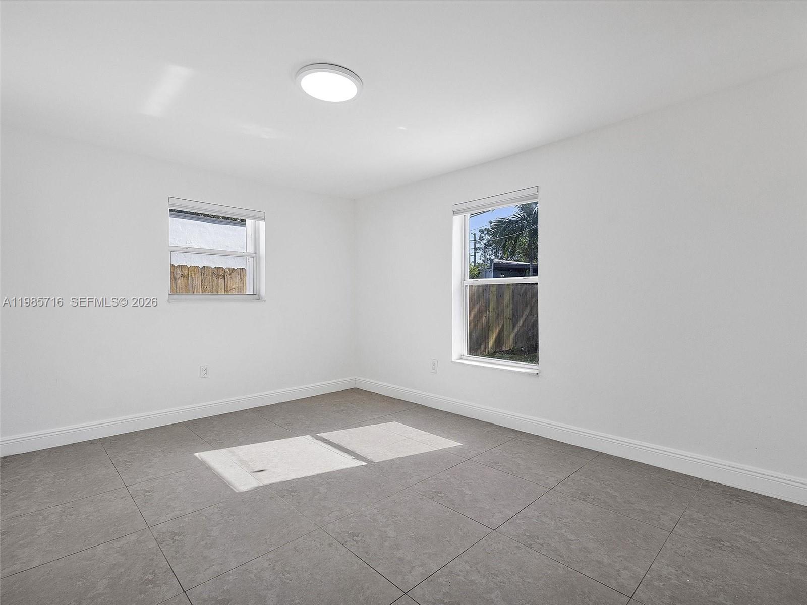 340 Northwest 45th Street Miami, FL 33127 - Photo 17 of 25 an empty room with windows