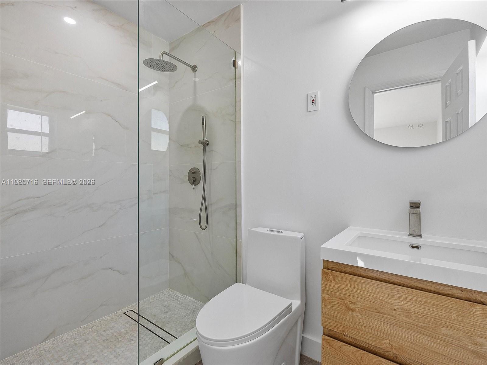 340 Northwest 45th Street Miami, FL 33127 - Photo 19 of 25 a bathroom with a toilet a sink and shower