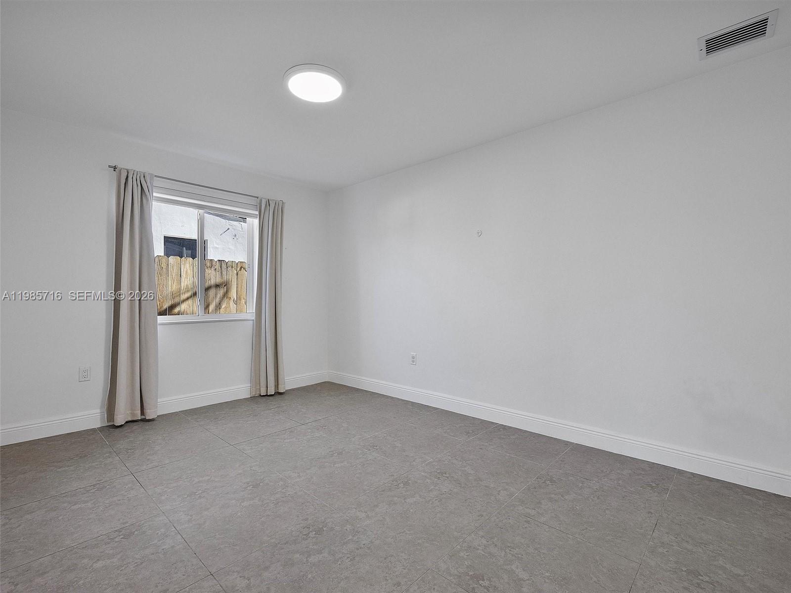 340 Northwest 45th Street Miami, FL 33127 - Photo 20 of 25 a view of an empty room with a window