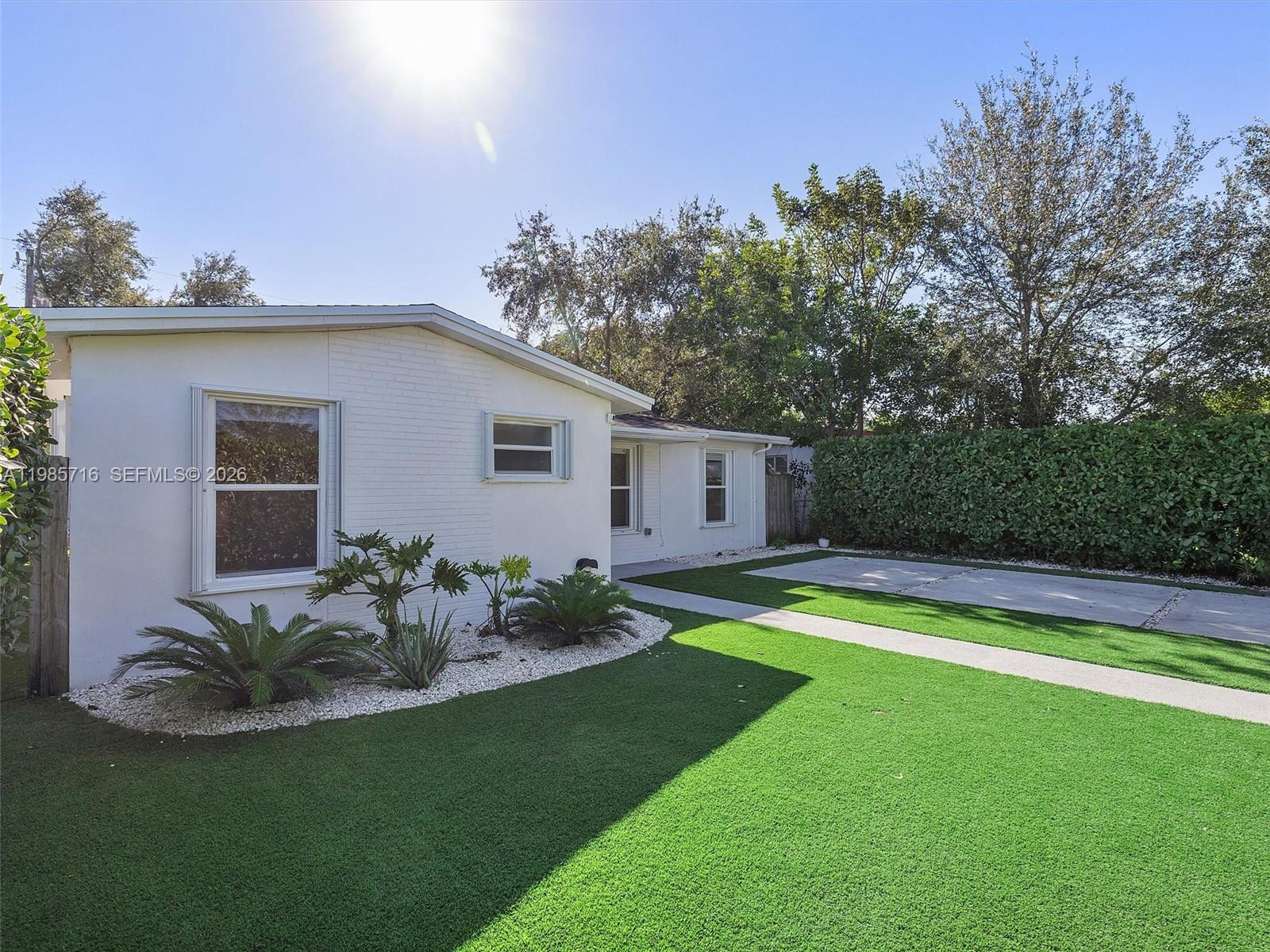 340 Northwest 45th Street Miami, FL 33127 - Photo 2 of 25 a view of a house with pool and a yard