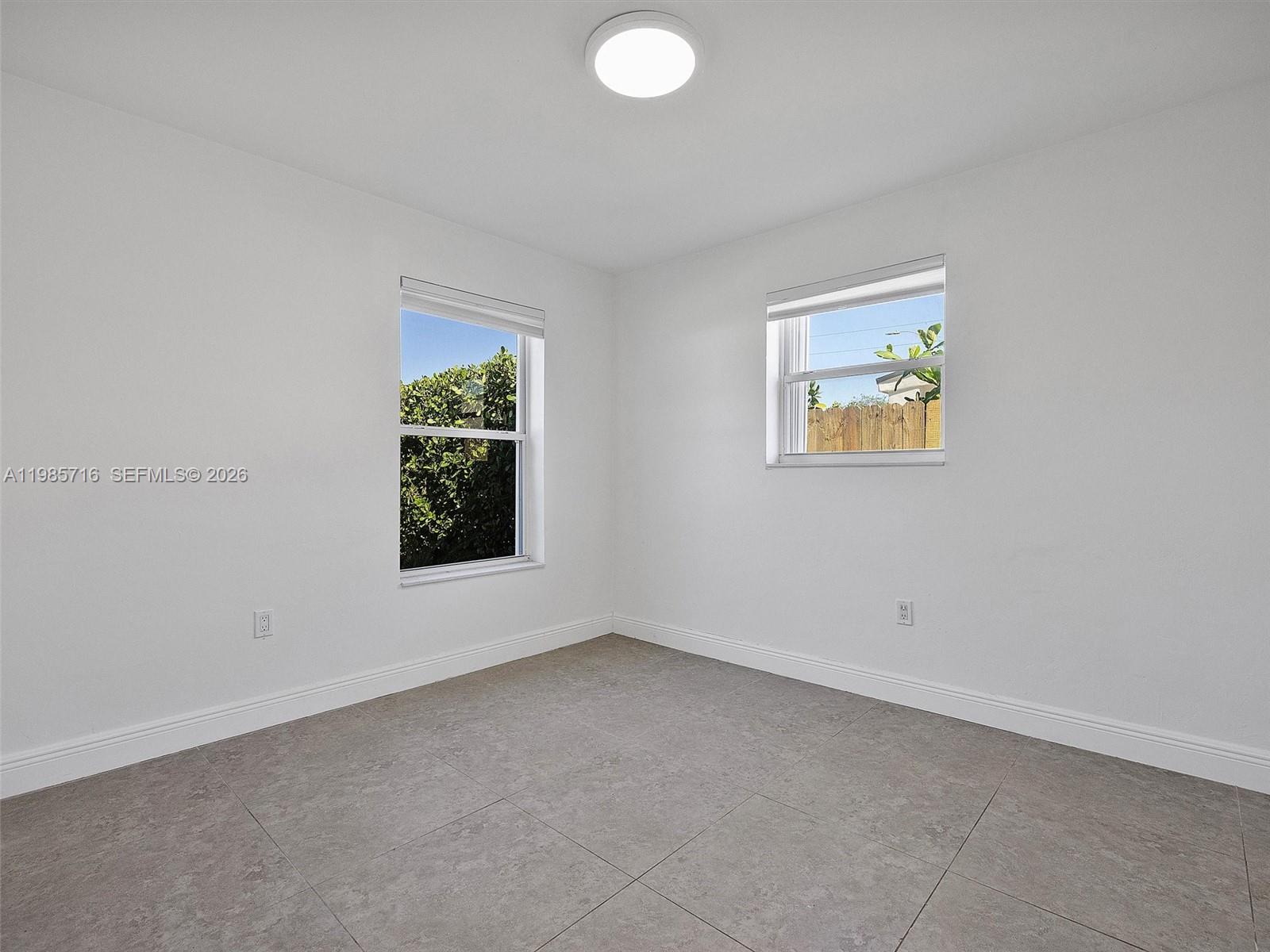 340 Northwest 45th Street Miami, FL 33127 - Photo 21 of 25 an empty room with windows and window