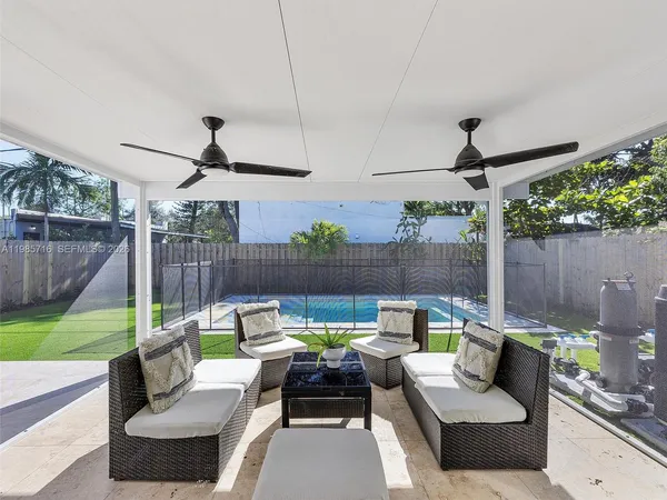 a view of a patio with couches chairs and a fire pit