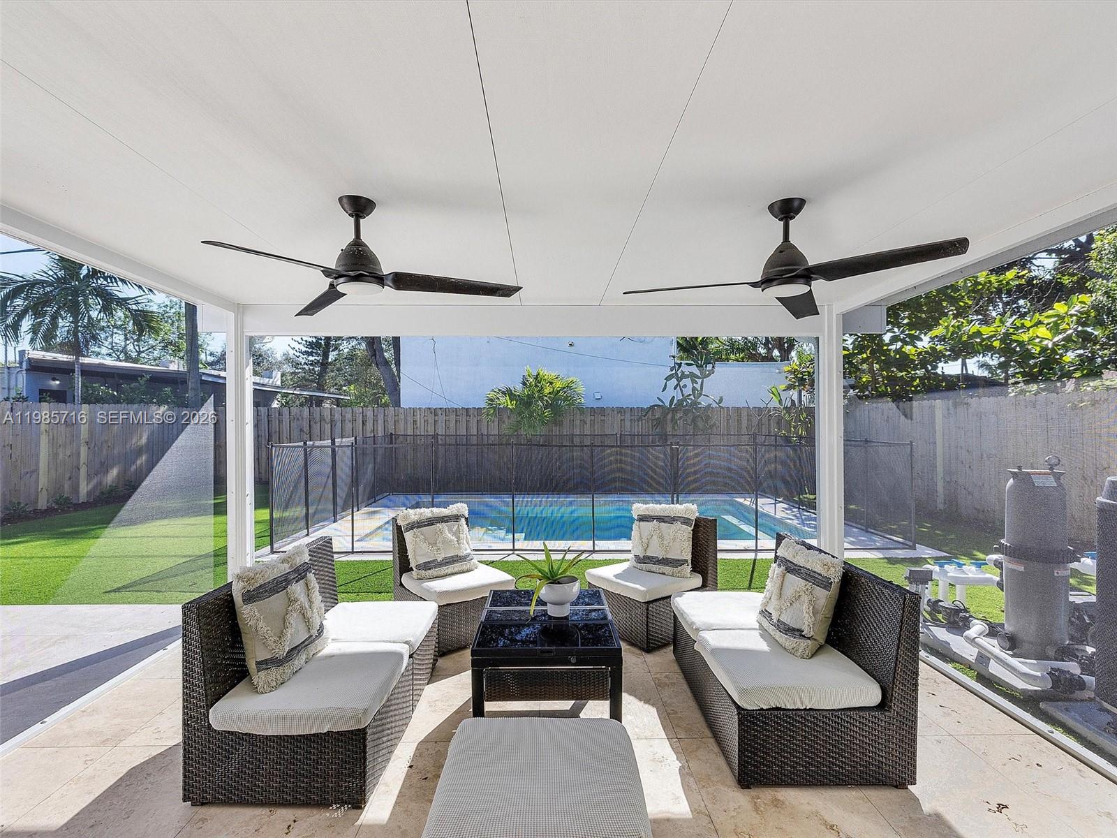 340 Northwest 45th Street Miami, FL 33127 - Photo 4 of 25 a view of a patio with couches chairs and a fire pit
