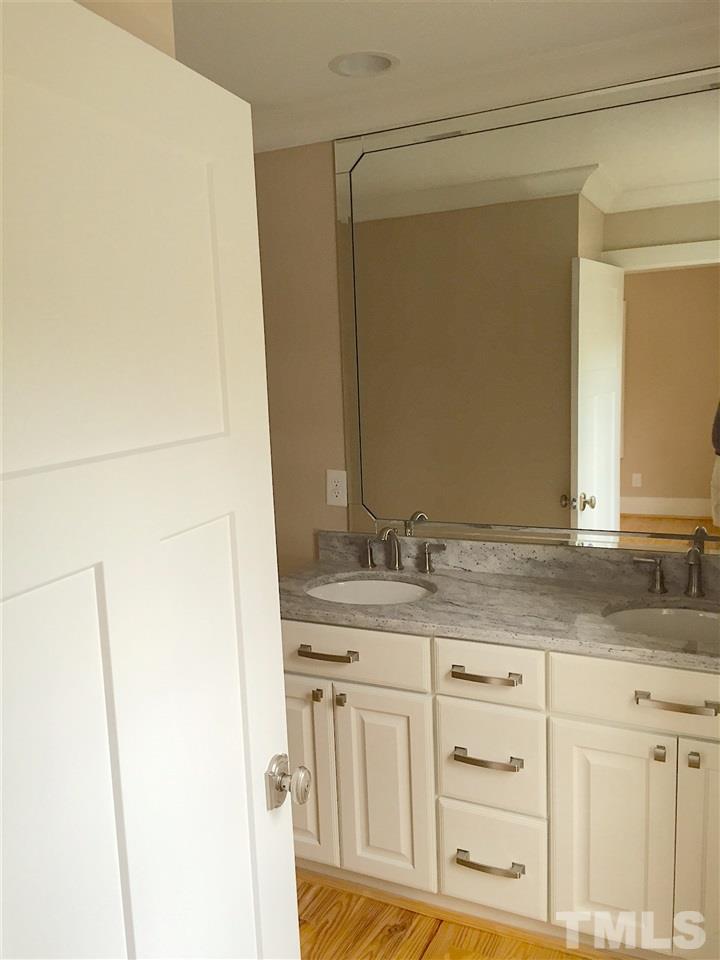 3132 Stanhope Avenue Raleigh, NC 27607 - Photo 7 of 11 a bathroom with a granite countertop sink and a mirror