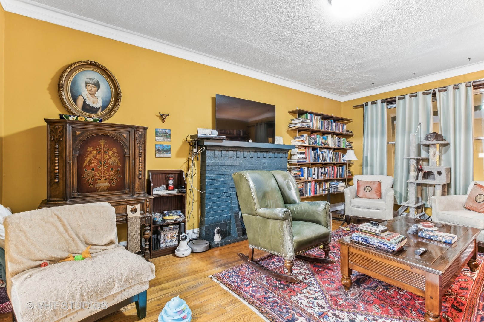 1622 West Devon Avenue Chicago, IL 60626 - Photo 33 of 36 a living room with furniture a flat screen tv and a fireplace