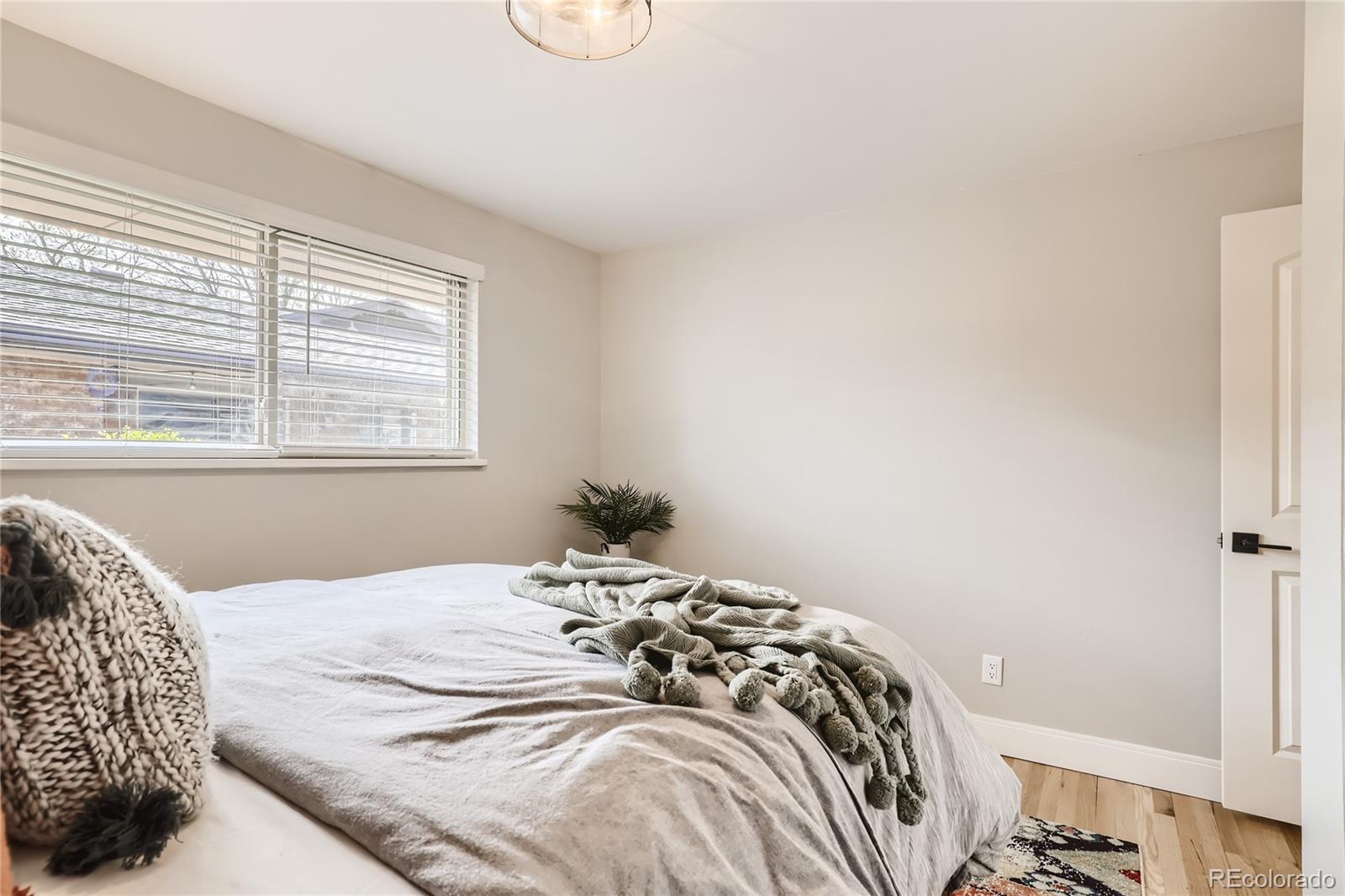 11676 West 37th Place Wheat Ridge, CO 80033 - Photo 11 of 30 a bedroom with a bed and a window