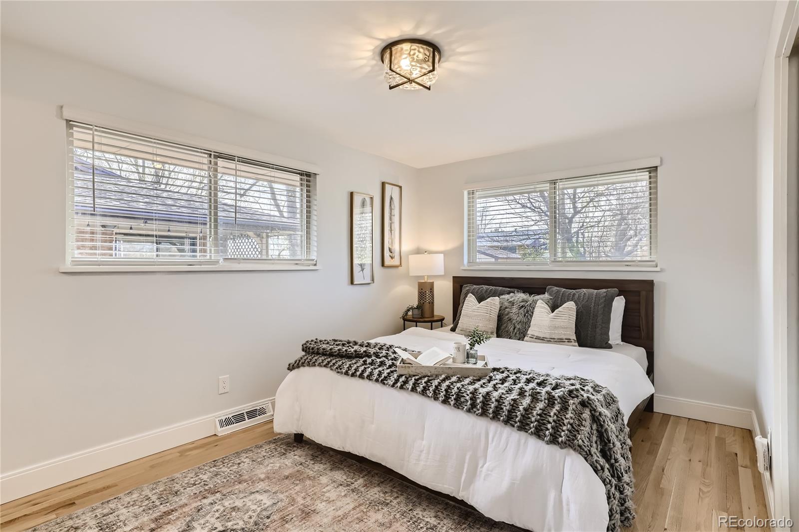 11676 West 37th Place Wheat Ridge, CO 80033 - Photo 13 of 30 a bedroom with a large bed and a window