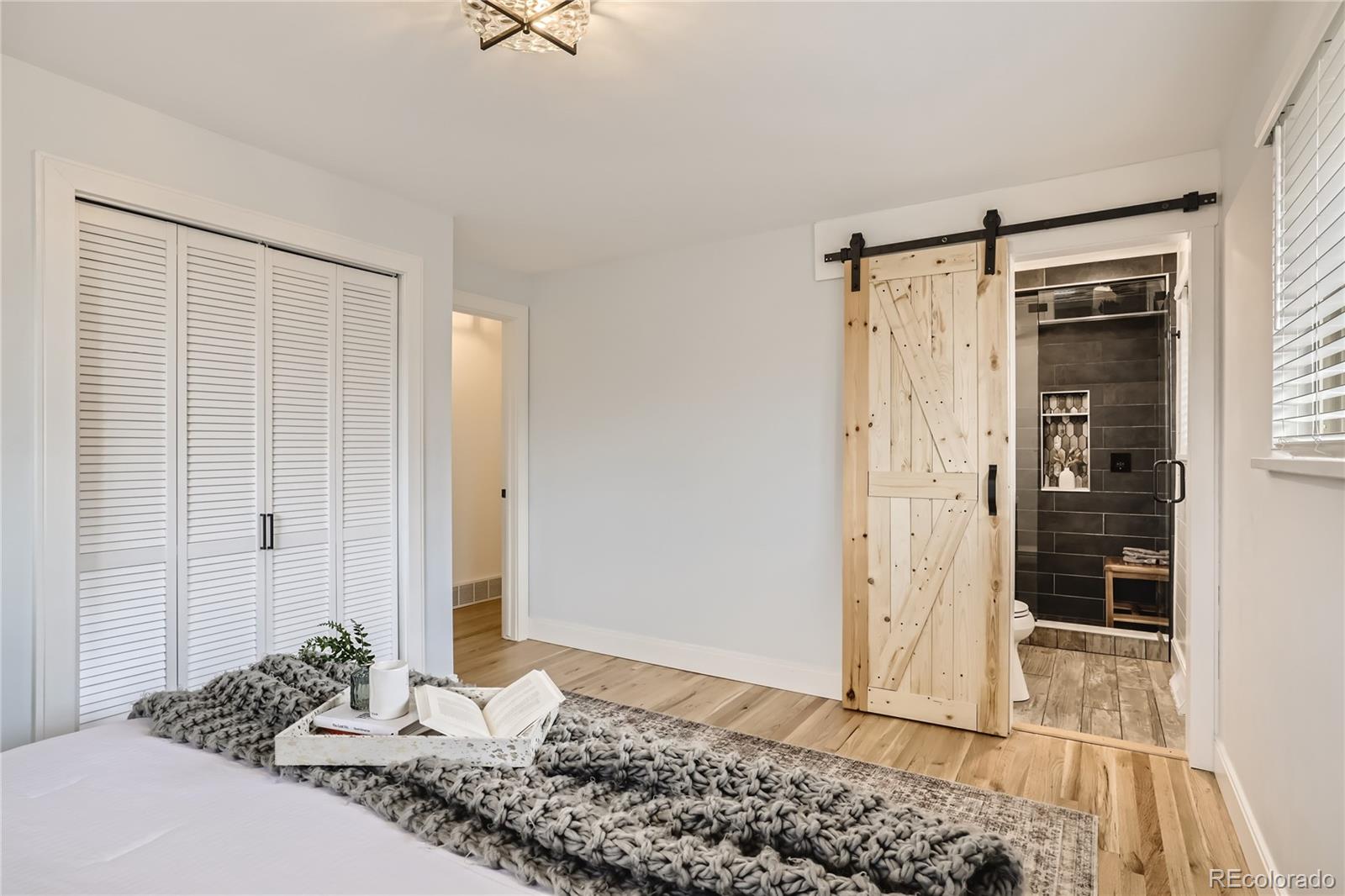 11676 West 37th Place Wheat Ridge, CO 80033 - Photo 14 of 30 a bedroom with a bed and a walk in closet