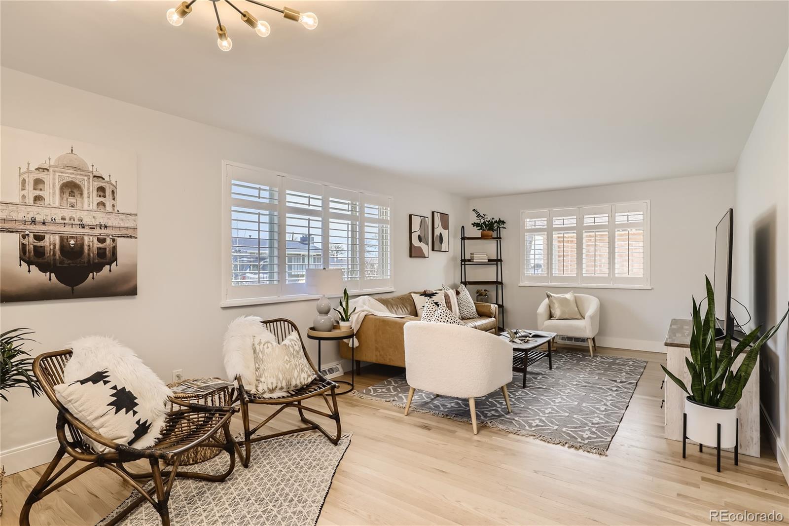 11676 West 37th Place Wheat Ridge, CO 80033 - Photo 5 of 30 a living room with furniture a flat screen tv and a large window