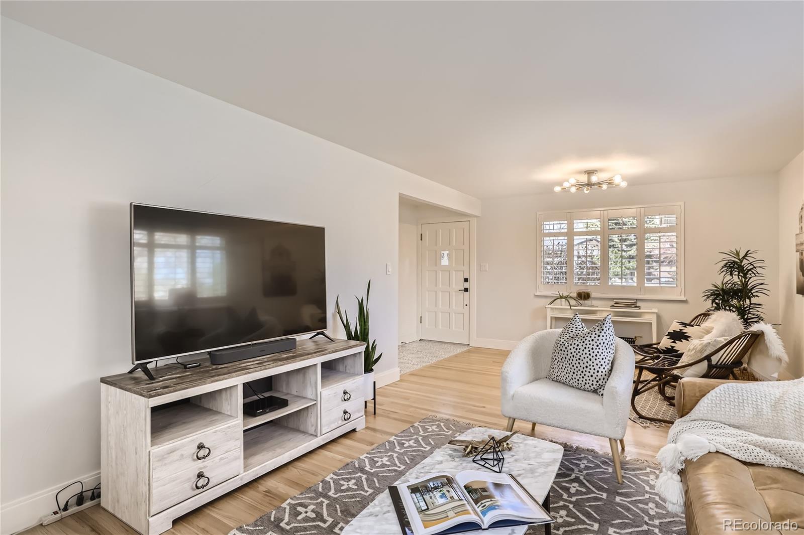 11676 West 37th Place Wheat Ridge, CO 80033 - Photo 6 of 30 a living room with furniture and a flat screen tv