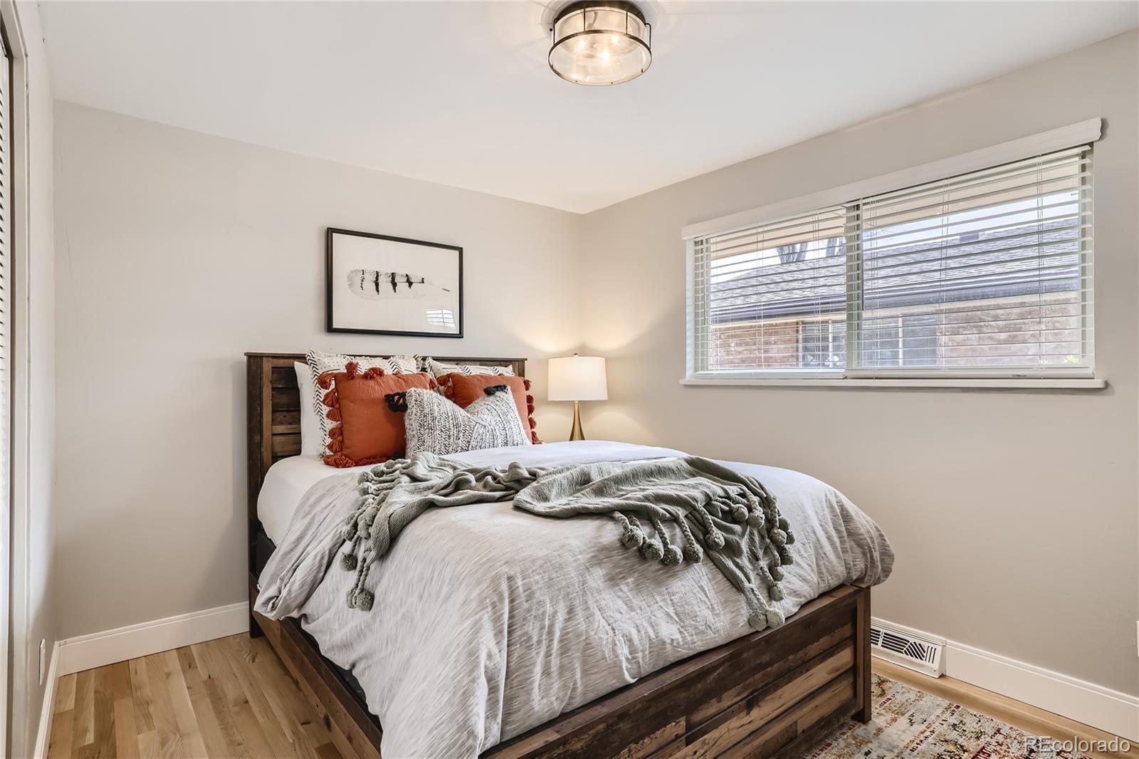11676 West 37th Place Wheat Ridge, CO 80033 - Photo 10 of 30 a bed sitting in a bedroom next to a window