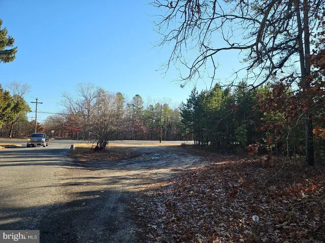 a view of a yard with wooden fence