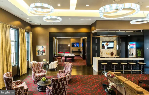 a living room with furniture a window and a chandelier