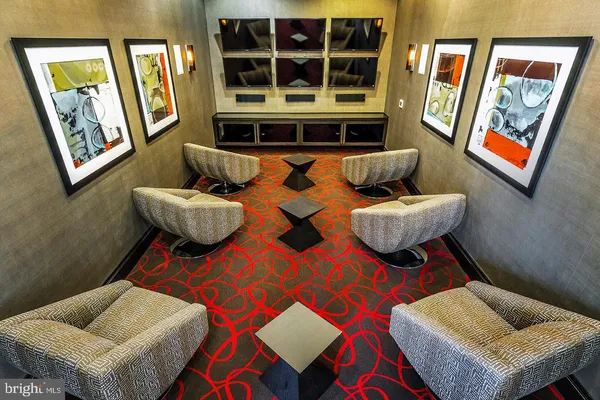 a living room with furniture and painting on the wall