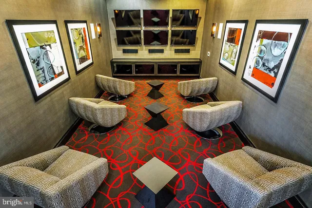 a living room with furniture and painting on the wall