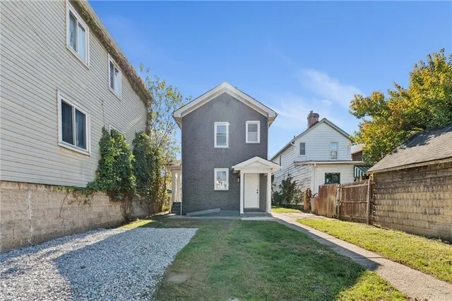 a front view of a house with a yard