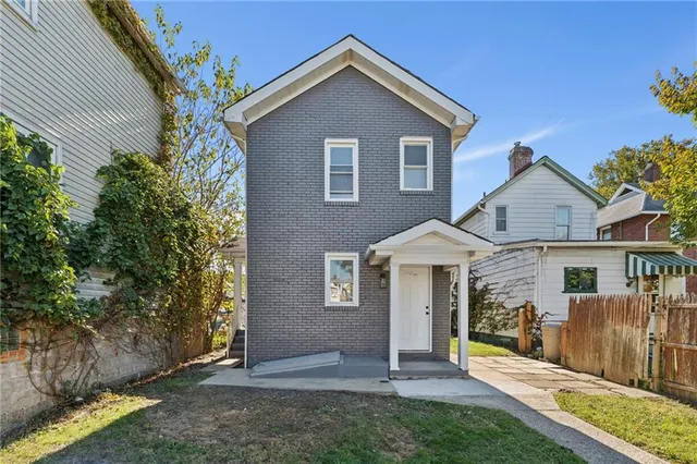 a front view of a house with a yard