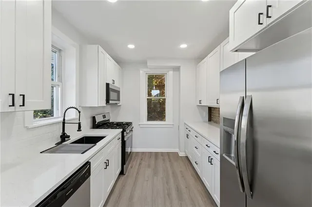 a kitchen with a sink stove and refrigerator