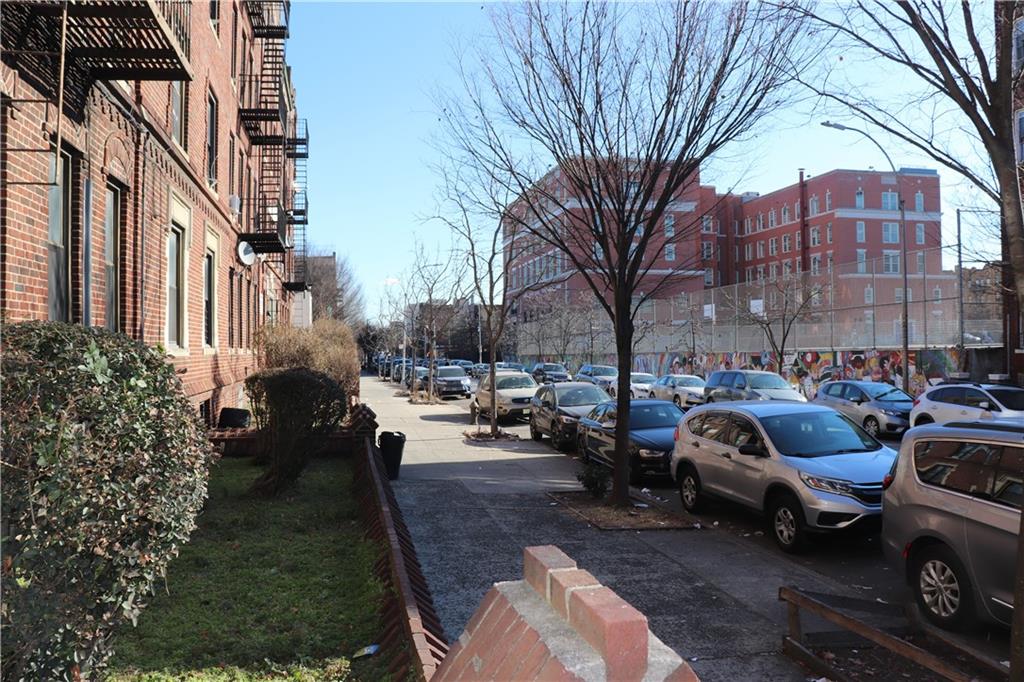 1405 Prospect Place, Unit B14 Brooklyn, NY 11213 - Photo 16 of 16 a city street lined with parked cars and buildings