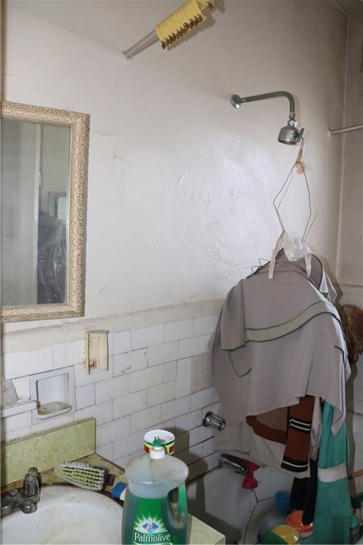 1405 Prospect Place, Unit B14 Brooklyn, NY 11213 - Photo 9 of 16 a bathroom with a sink and a mirror
