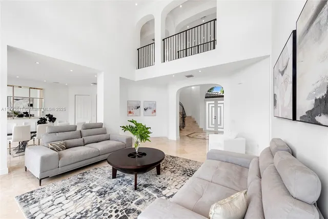 a living room with furniture large window and a flat screen tv