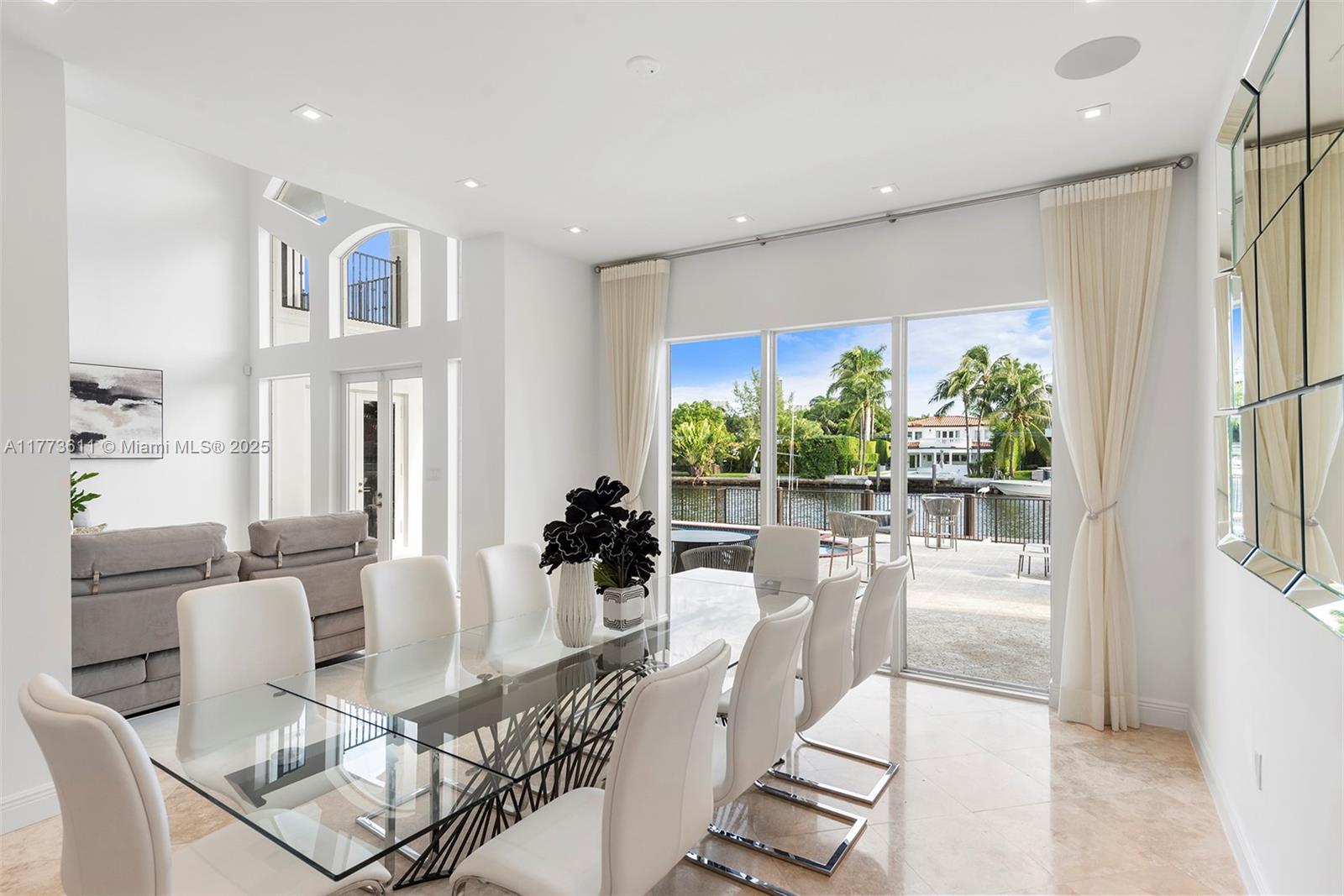 455 Centre Island Golden Beach, FL 33160 - Photo 17 of 67 a dining room with furniture a chandelier and wooden floor