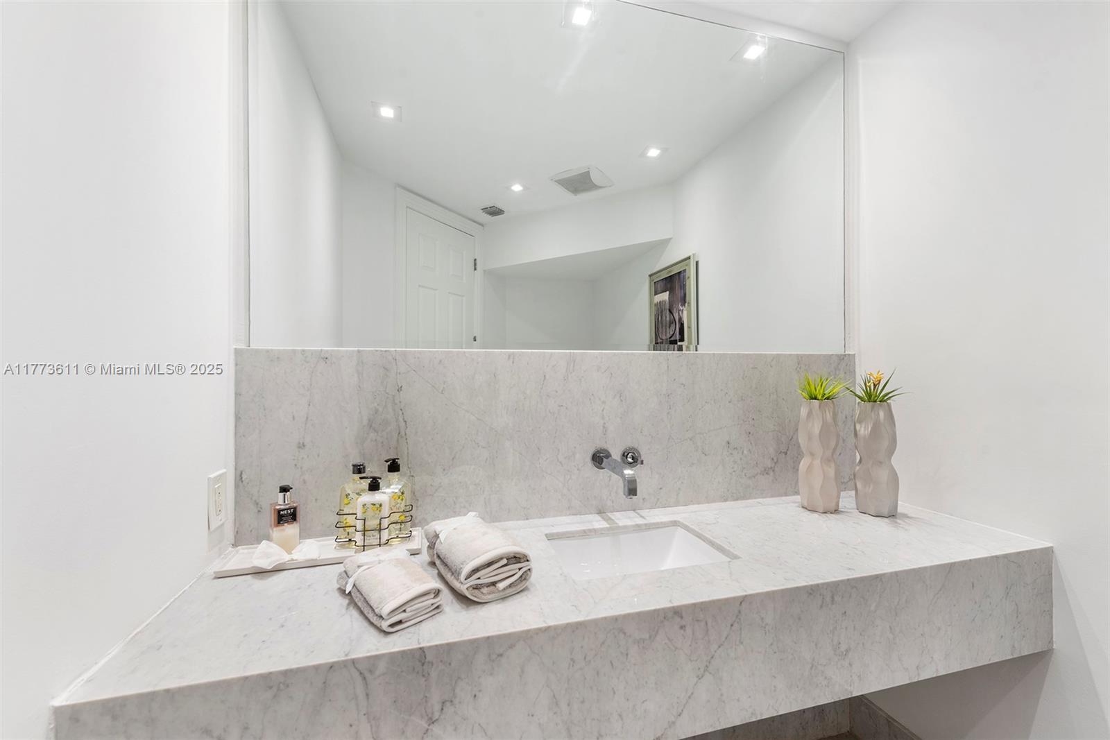 455 Centre Island Golden Beach, FL 33160 - Photo 18 of 67 a bathroom with a sink and a mirror