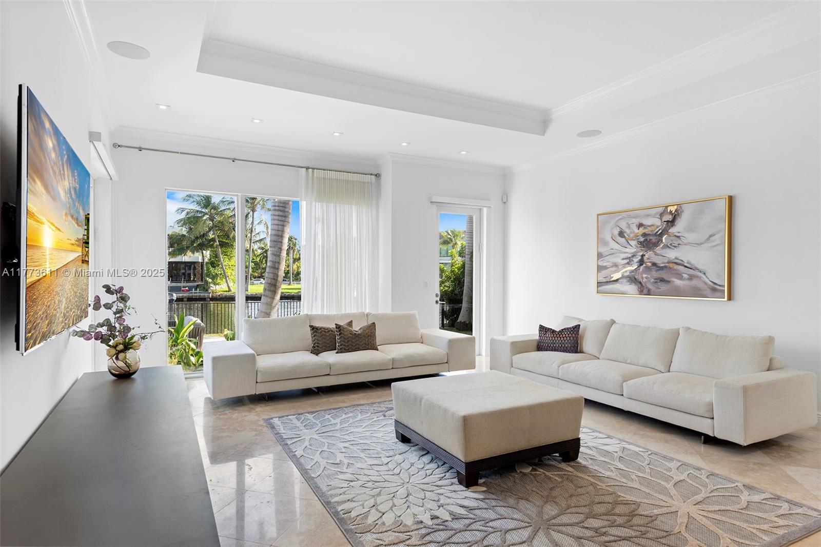 455 Centre Island Golden Beach, FL 33160 - Photo 20 of 67 a living room with furniture large window and a flat screen tv