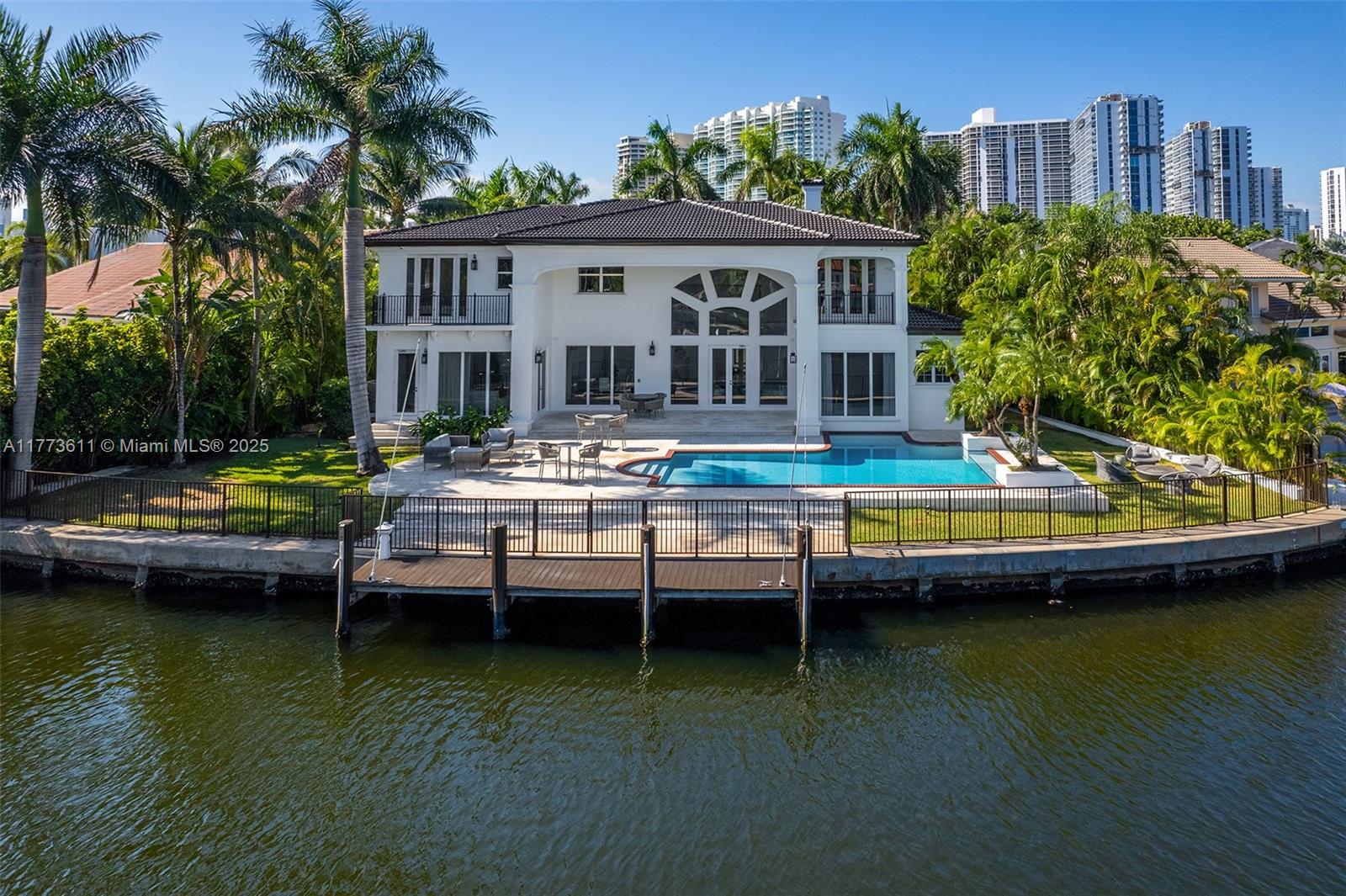 455 Centre Island Golden Beach, FL 33160 - Photo 2 of 67 a view of house with swimming pool yard and outdoor seating